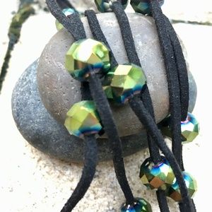 Set of hexagon shaped green beads on leather necklace and earrings.